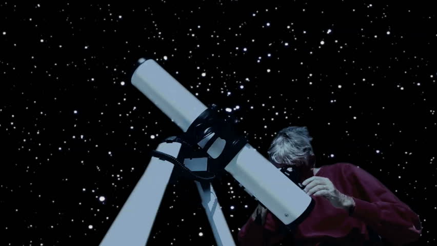 Man looks at night sky through home telescope.