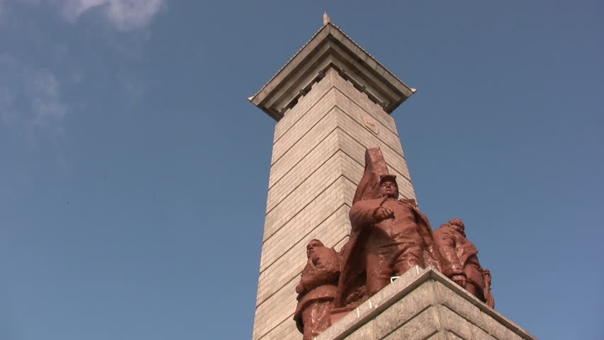 Communist pillar with birds and blue skies