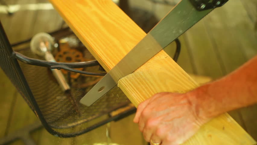 Sawing a piece of wood for deck repair