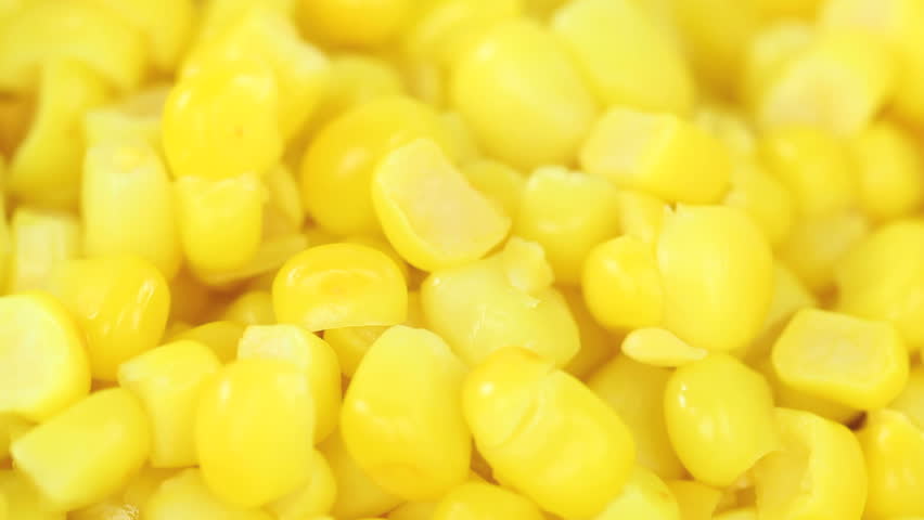 Corn closeup background, heap of yellow corn filling the screen entirely, slowly rotating in a seamless loop