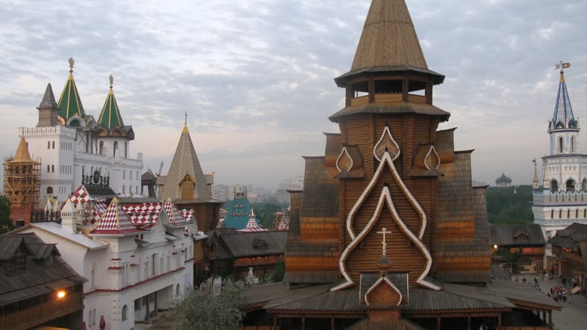 Roofs of Old Russian buildings stand against cloudy sky, time lapse

