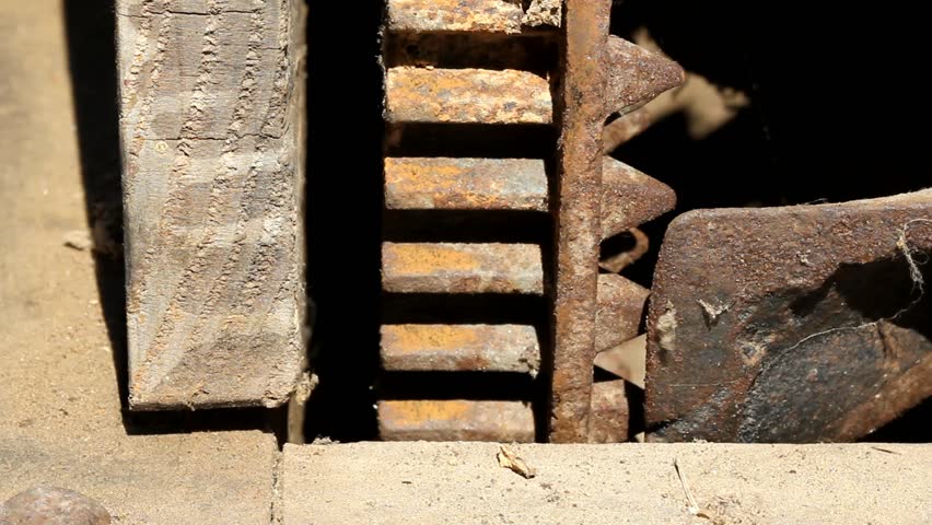Static View Of Dusty Wood And Rusty Gear In A Breeze