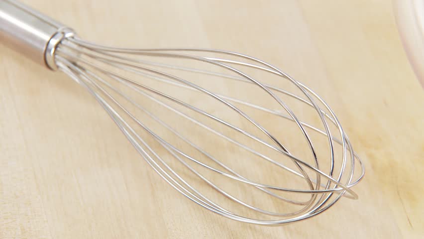 Ingredients for mayonnaise being mixed with a whisk