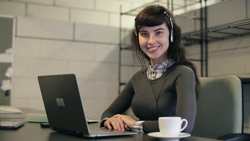Friendly happy female helpdesk consultant in the office
