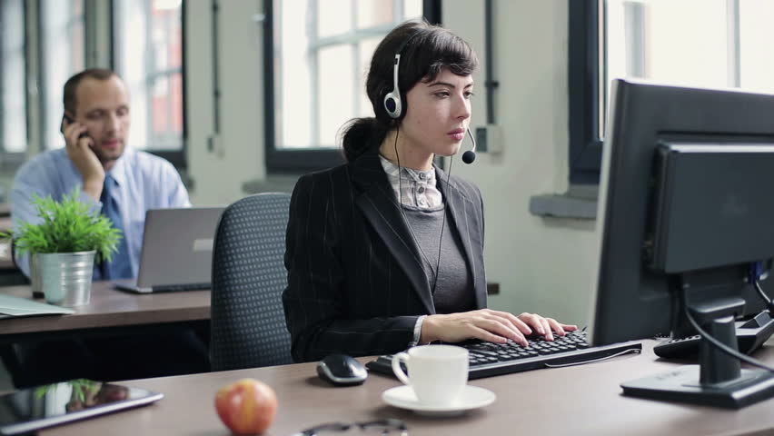 Friendly happy female helpdesk consultant in the office
