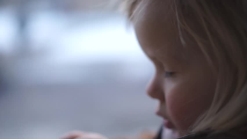 Adorable baby ride on tram seat near window