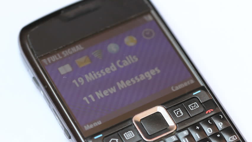 Close up shot of a cellphone screen with incoming call from a stalker