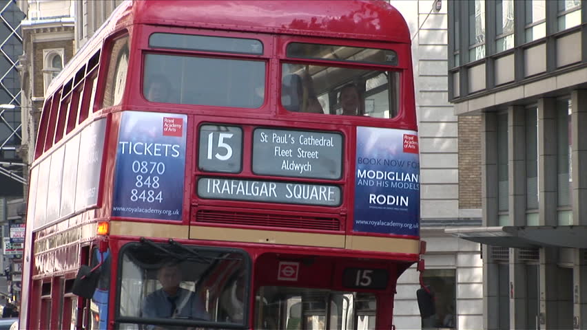London, England - CIRCA June, 2006: A zoom out of a busy city street full of cabs and double decker buses
