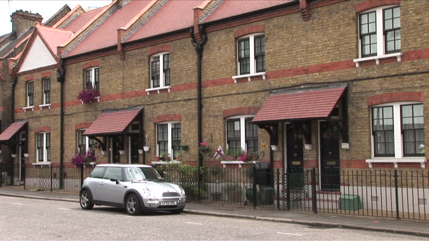 London, England - CIRCA June, 2006: A car sits outside a typical row of British houses