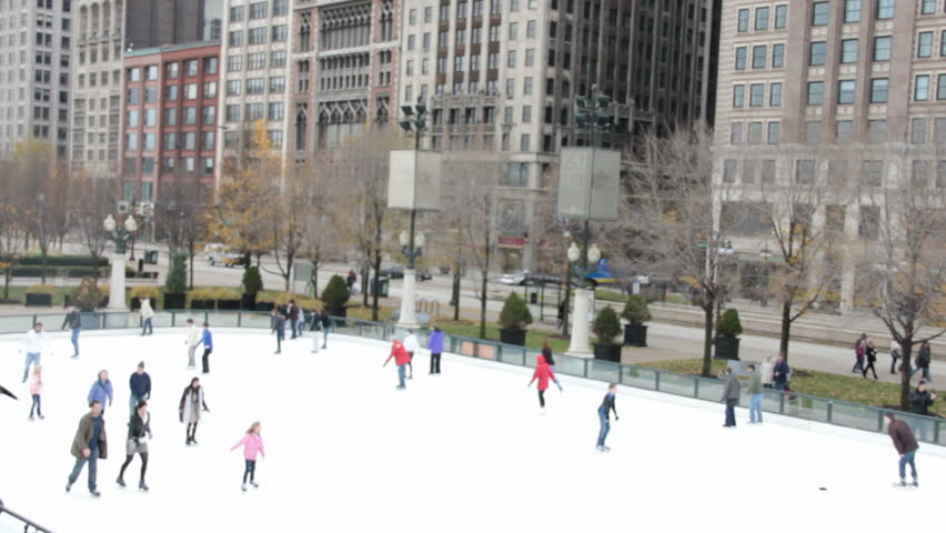 A de-focused clip of people skating in downtown Chicago during the holidays.