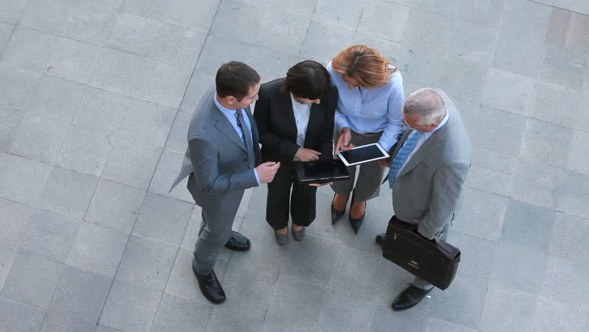 Partners discussing business matter outdoors on neutral territory