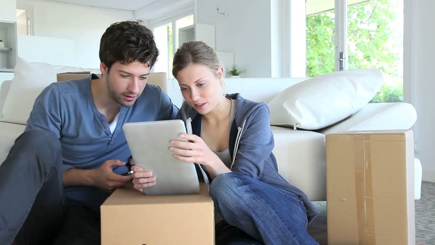 Young couple using tablet to find transport company