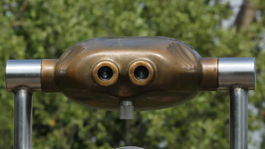 Tourist binoculars with breezy trees in the background. Shallow depth of field. Ontario, Canada.  