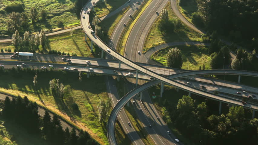 Aerial perspective of interstate commuter traffic crossing bridge on clear, early morning