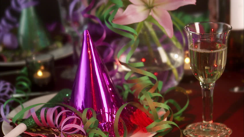 A glass of wine on a table laid for a party.
