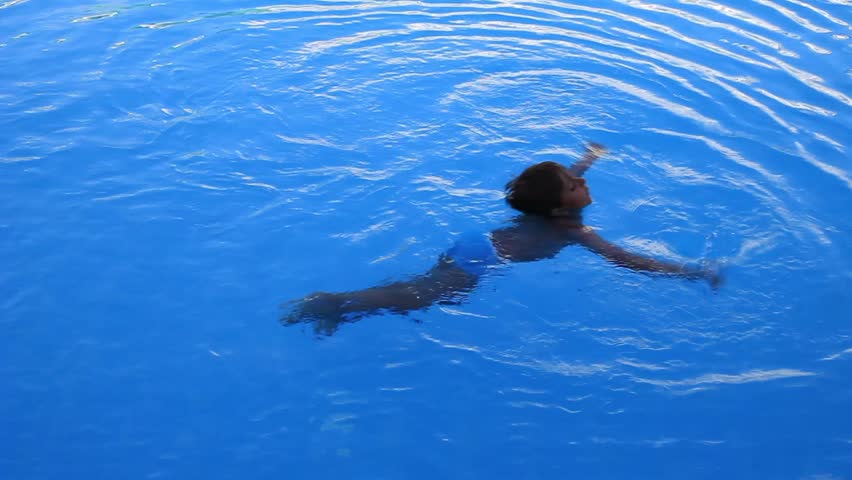 child swims in the pool