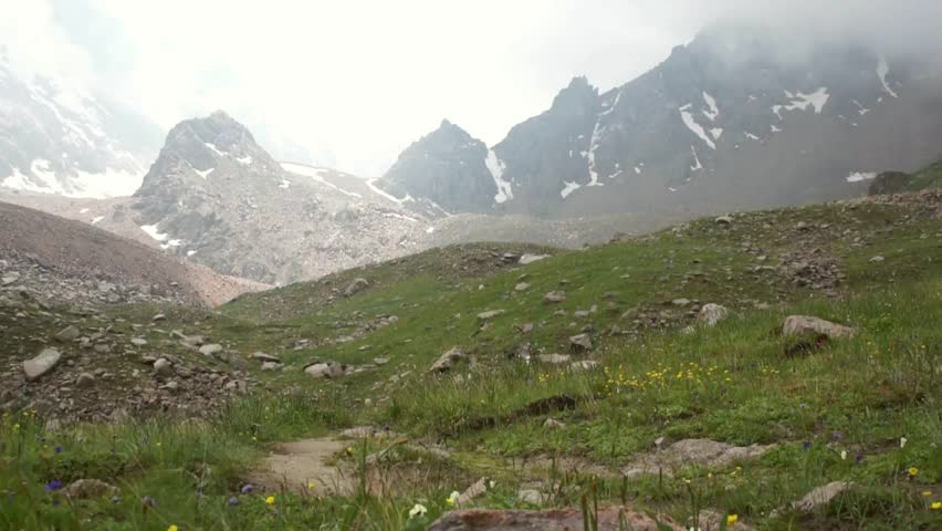 Young boy walking in the high Alps mountains