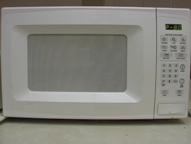 Microwave cooking a delicious meal.
