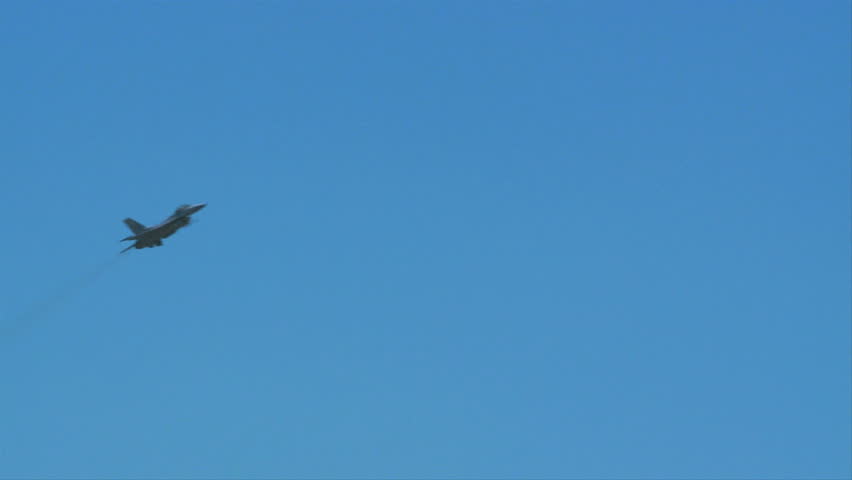 QUONSET, RHODE ISLAND - JUNE 2012: Air force F-16 Falcon flying by while rolling at the Rhode Island National Guard Open House and Air Show in June 2012.