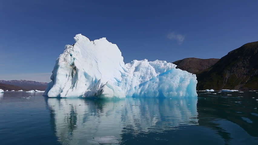 Drifting by an iceberg floating in Qooroq Icefjord, South Greenland