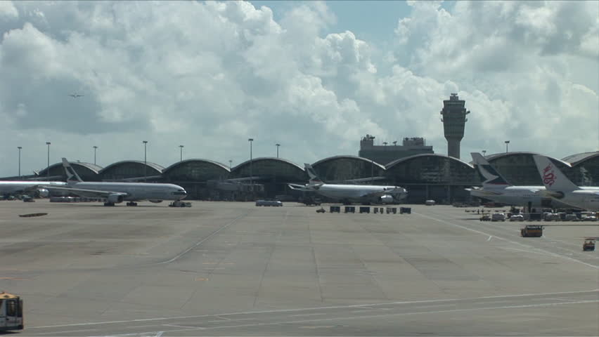 Hong Kong, China - CIRCA April, 2007: Different vehicles are in motion on the tarmac of the Hong Kong International Airport during a beautiful day