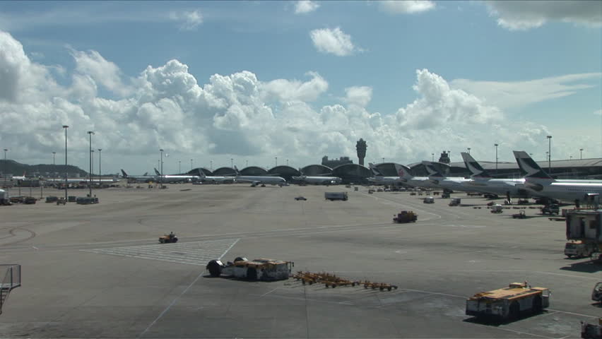 Hong Kong, China - CIRCA April, 2007: Different vehicles are in motion on the tarmac of the Hong Kong International Airport during a beautiful day
