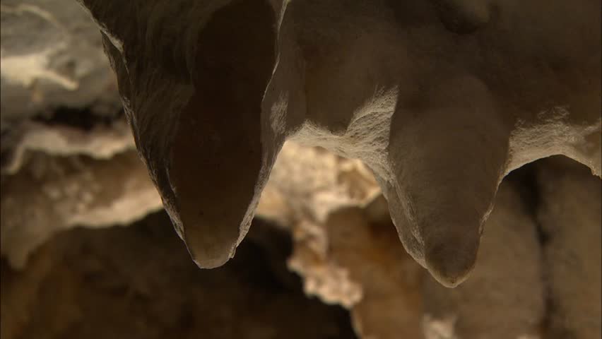 Dramatic lighting on broken stalactites in cave