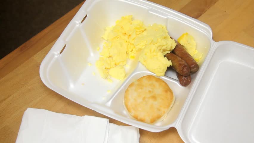 Plastic Fork Pushes Some Scrambled Eggs Around In Styrofoam Tray