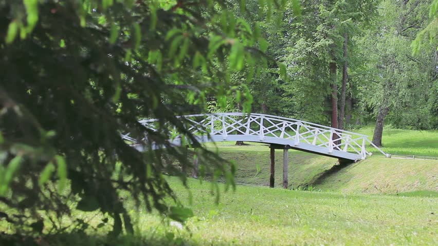 White wooden bridge over a dry creek in the mountains of Pushkin slip the camera from left to right/A wooden bridge across the creek dried up in the estate of the poet Alexander Pushkin