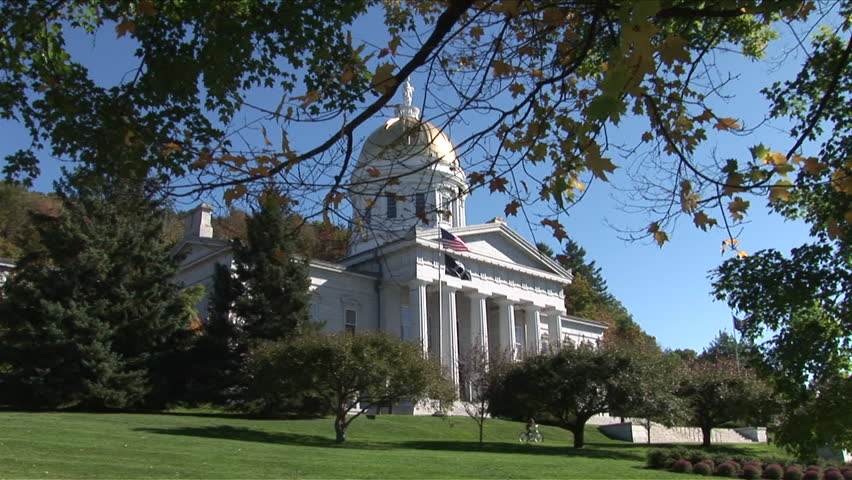 Montpelier, Vermont - CIRCA September 2007: Wide view of the State Capitol Building sitting on a green lawn with trees during the day