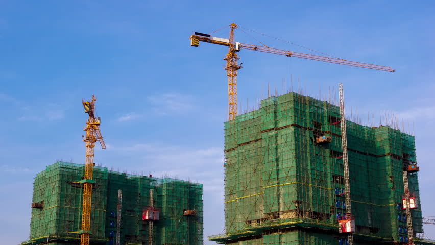 Time lapse of Building Under Construction, Crane and bamboo scaffolding used for the construction of a skyscraper, 