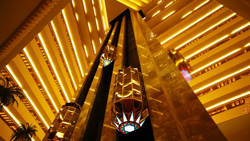 Wide angle view of the interior elevators going up and down inside a luxury hotel in Doha, Qatar