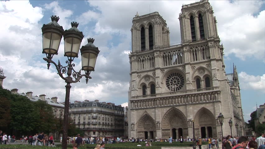 Paris, France - CIRCA June, 2006: Wide view of the Notre Dame Cathedral  with a large crowd out front as seen during the day