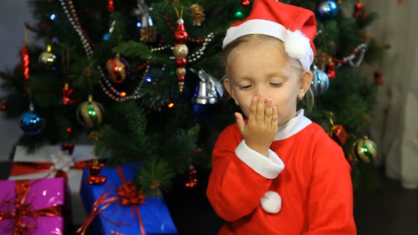 Child Kissing Santa Claus Near Christmas Tree