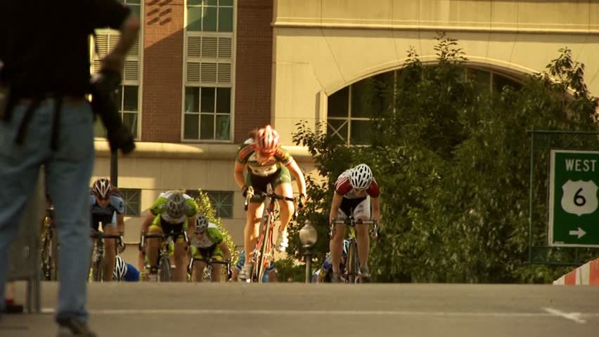 PROVIDENCE, RHODE ISLAND - SEPTEMBER 3, 2009: Woman bicycle racer winning race and celebrating as she crosses finish line- slow motion