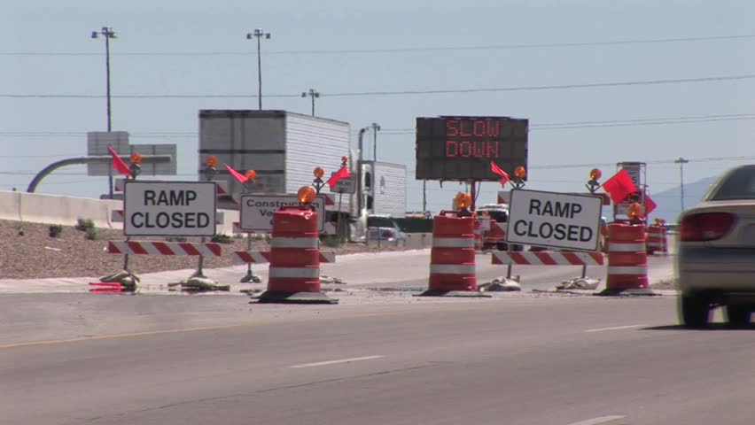 Ramp Closed Road Sign Block Entry To A Freeway; Flashing Detour Sign In The Background 2
