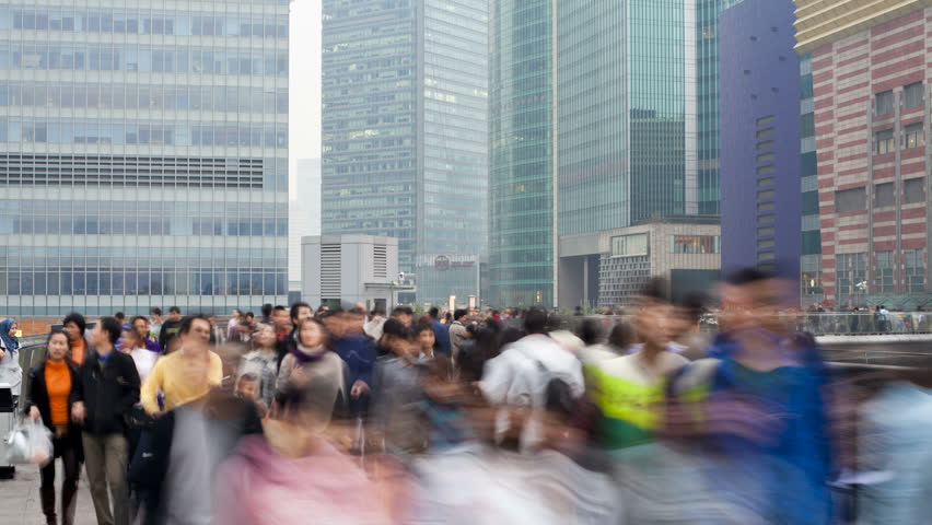 SHANGHAI, CHINA - CIRCA MAY 2011: Circular pedestrian walkway above a traffic roundabout with people walking by