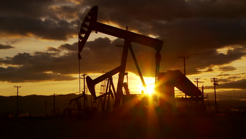 Oil well piston pumps at sunset