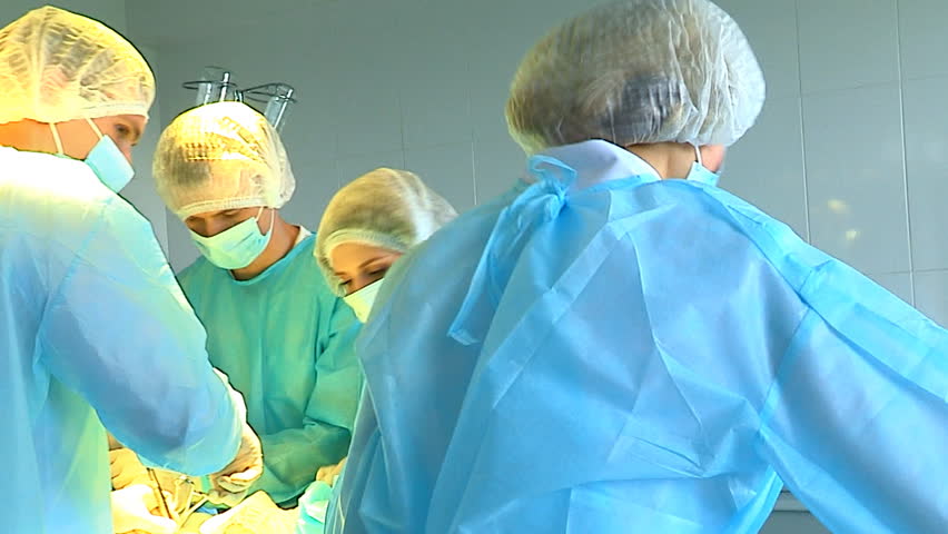 Team surgeon at work in operating room.