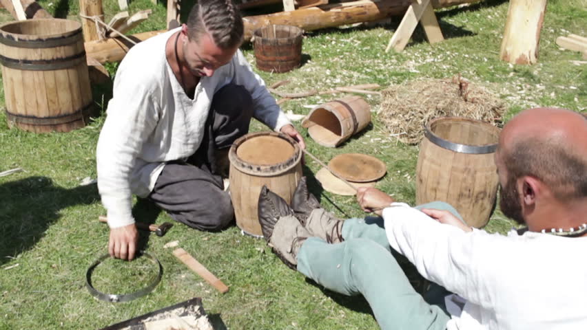 MOSCOW - JULY 7: Two workers are making a barrel in a traditional style at the Times and Epochs historical re-enactment festival on July 7, 2012 in Moscow, Russia. The annual festival showcases Russian history between the 10th to the 20th century.