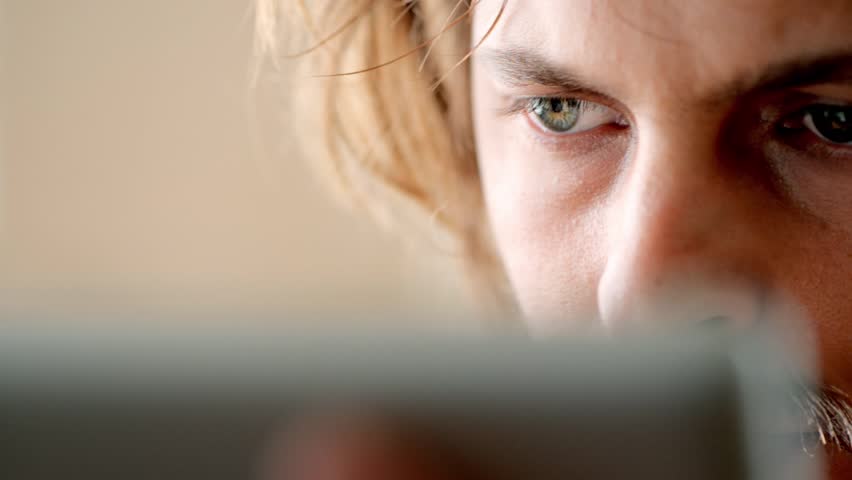 Attractive young man using tablet computer touchscreen