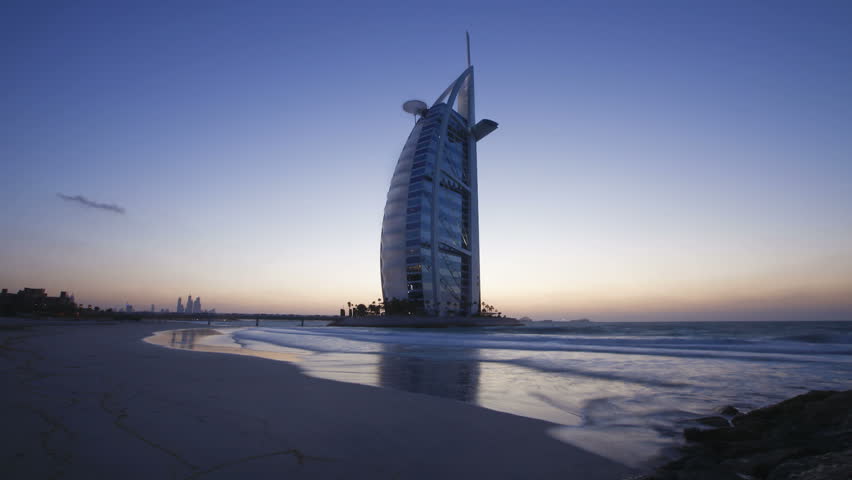 DUBAI, UNITED ARAB EMIRATES - CIRCA MAY 2011: transition from dusk to night showing the illumination on the modern elegantly designed Burj Al Arab Hotel.