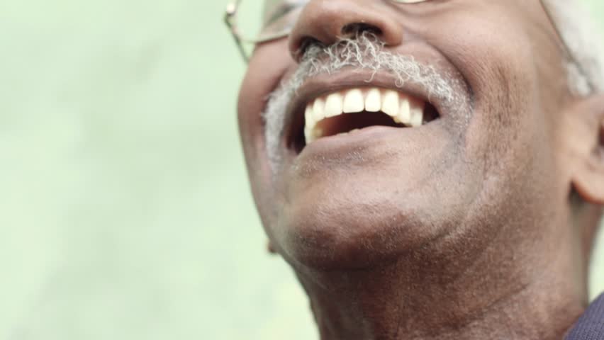 Seniors and feelings, elderly black man with glasses and mustache smiling. Slow motion
