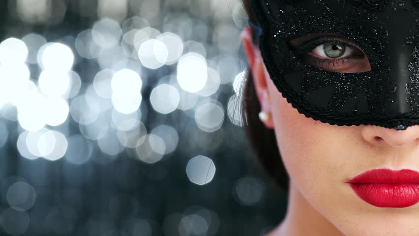 Macro closeup of sexy woman wearing masquerade mask at party