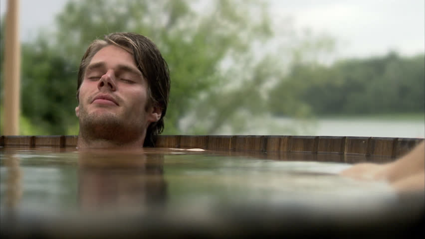 A man sitting in a bath tub