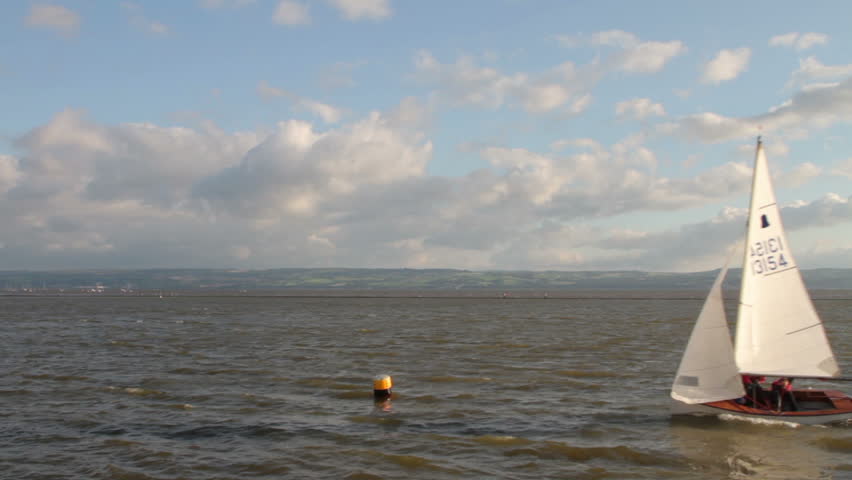 WIRRAL, CHESHIRE/ENGLAND - JUNE 12: A sailing dinghy tacks round a buoy on West Kirby Marine Lake on June 28, 2012 in Wirral. The Marine Lake is a man made coastal lake fed by the sea at high tide.