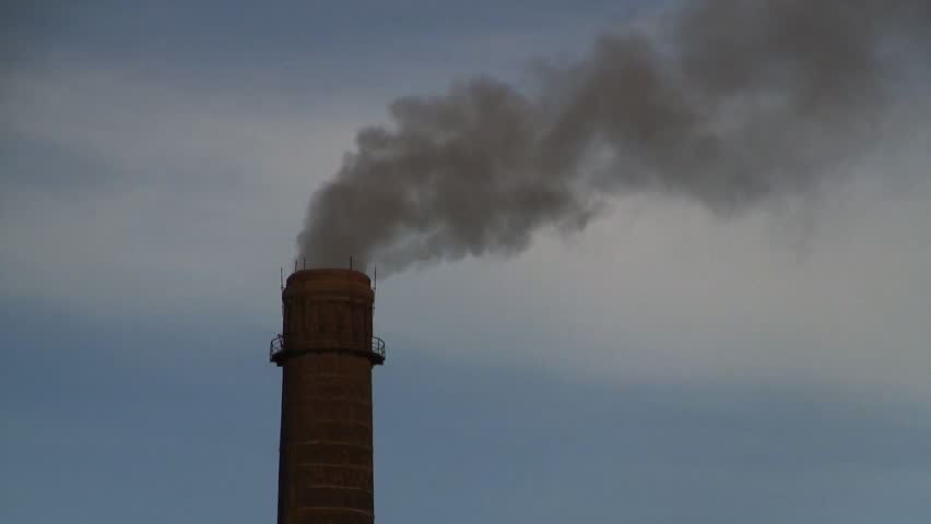 Gray smog coming from industrial chimney of heating plant polluting air