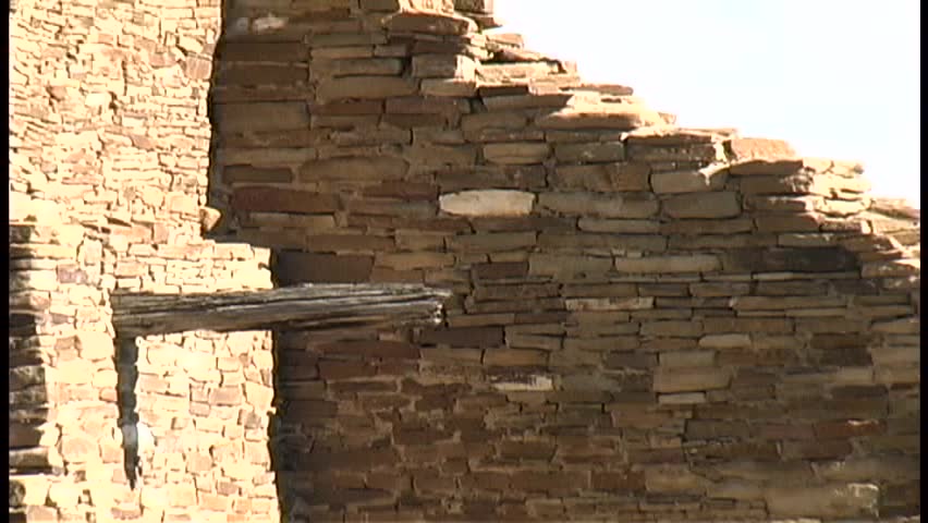 A zoom into a tight shot of the stonework and logs in the walls of Pueblo Bonito, the largest Anasazi ruin in Chaco Canyon National Cultural Center in northern New Mexico, followed by a zoom out.