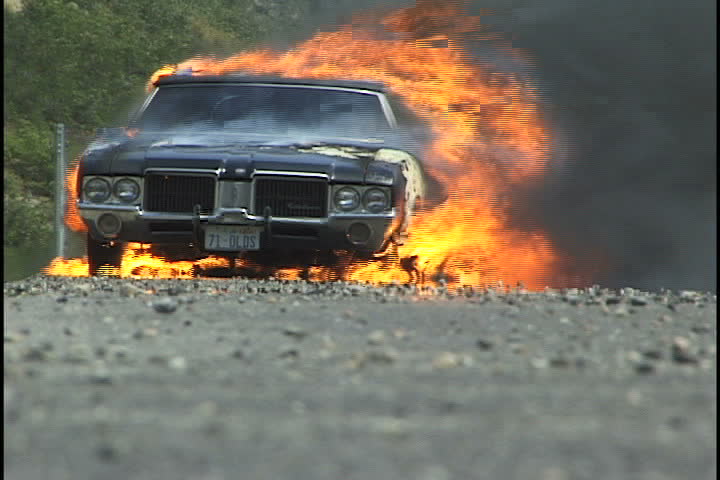 Salt Lake City, UT - July 2000: Classic car burns on side of highway. Interstate 80 West near Salt Lake City, Utah