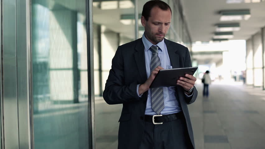 Businessman working on tablet computer in the city
